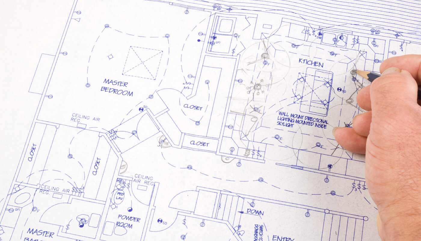 Close-up of a residential floor plan being marked up by hand